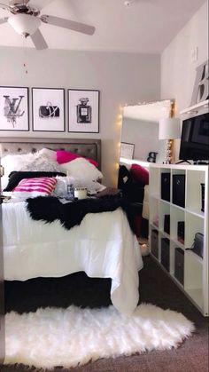 a bedroom with a bed, dresser and pictures on the wall above it's headboard