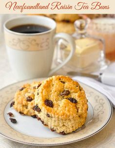 two oatmeal raisin tea cookies on a plate with a cup of coffee