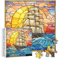 a stained glass window with a sailboat in the ocean and sun setting behind it