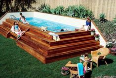 two people sitting in an above ground swimming pool surrounded by lawn chairs and tables with plants