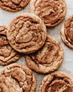 a bunch of cookies sitting on top of a white tablecloth covered in powdered sugar