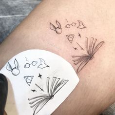 a tattoo on the leg of a person with writing and symbols drawn on their legs