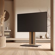 a flat screen tv sitting on top of a wooden floor