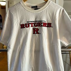 Xl Youth Size (20) Embroidered Rutgers White Tops With University Logo For Sports Season, White Tops With University Logo For Game Day, White Short Sleeve Top With University Logo, Collegiate White T-shirt With University Logo, White University Logo T-shirt For Game Day, White University Logo Top For College, White University Logo T-shirt With Crew Neck, White Fan Apparel Tops With University Logo, White Crew Neck T-shirt With University Logo