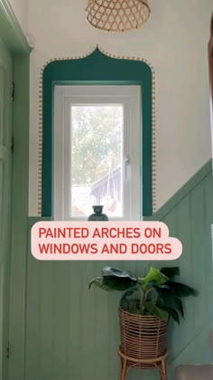 the interior of a house with painted arches on windows and doors in front of a potted plant