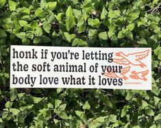 a sign that says honk if you're letting the soft animal of your body love what it loves