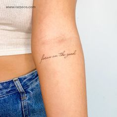 a woman with a tattoo on her arm that says, love is the reason and