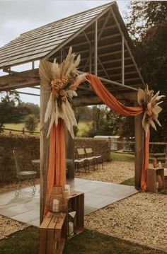 an outdoor wedding venue decorated with orange and white decor