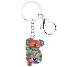 a keychain with a koala bear on it's back and the words we