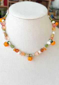 Embrace the beauty of fall with our stunning Pumpkin Patch Beaded Necklace! This charming piece is a perfect blend of autumn hues and festive cheer, making it an ideal accessory for the season. Handcrafted with care, each necklace features a delightful array of beads in rich oranges, warm browns, and deep greens, reminiscent of a cozy pumpkin patch. The necklace is adorned with intricately designed pumpkin charms that capture the essence of the harvest season. Whether you're celebrating Halloween, Thanksgiving, or simply want to add a touch of fall to your wardrobe, this necklace is the perfect choice. It's versatile enough to pair with casual outfits or to add a festive flair to your evening wear. Key Features: *Handmade: Every necklace is carefully crafted by hand, ensuring a unique and Handmade Bohemian Halloween Necklace, Handmade Multicolor Jewelry For Fall, Handmade Bohemian Jewelry For Fall, Fall Necklaces Beaded, Fall Necklaces, Fashion Costume Halloween, Fall Pumpkin Patch, Thanksgiving Jewelry, Warm Browns