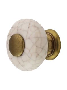 a white and gold door knob with an oval handle