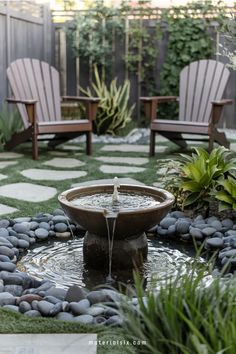 A peaceful garden with a water fountain surrounded by smooth stones and greenery, two wooden chairs in the background on stone pavers. Easy Backyard Landscaping, Small Yard Design, Backyard Sitting Areas, Diy Backyard Projects, Budget Landscaping, Easy Backyard, Modern Garden Design, Small Deck, Backyard Landscaping Ideas