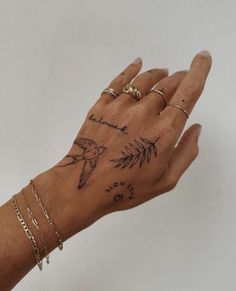 a person's hand with tattoos on it and two birds flying over the palm