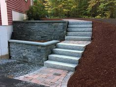 stone steps lead up to the side of a house