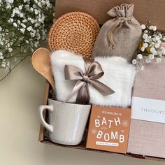 a gift box containing a mug, tea bag, and other items for the bath bomb