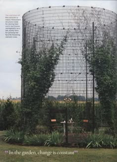 an advertisement for the garden is shown in front of a round structure with vines growing on it