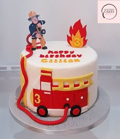 a birthday cake with a fireman on top and a fire hose attached to it