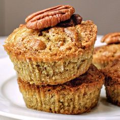 three muffins stacked on top of each other with pecans in the middle