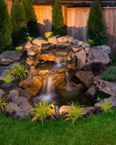 a small waterfall in the middle of a garden