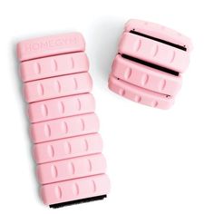 two pink combs sitting next to each other on a white surface