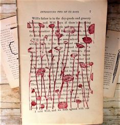 an old book with red flowers on it