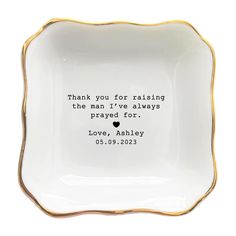 a white and gold plate with a quote on it