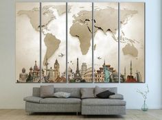 a living room area with a couch and three paintings on the wall, each depicting different countries