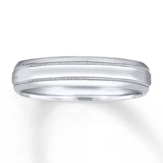 a white gold wedding band with engraved detail