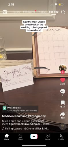 a wooden table topped with a notepad next to a glass of water and a pen