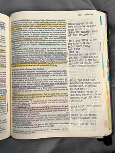 an open bible with colorful text on it