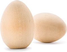 two wooden eggs sitting next to each other