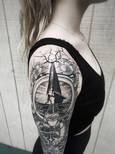 a woman's arm with a clock and flowers tattoo on her left side shoulder