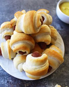 a white plate topped with pigs in a blanket