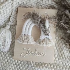 a card with two white hair clips on top of it