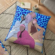 two women sitting on the floor in front of a blue leopard print square pillow, both with