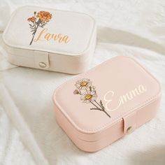 two personalized pink and white suitcases sitting on top of a bed next to each other