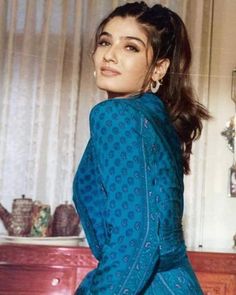 an old photo of a woman in a blue dress