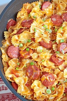 a skillet filled with pasta and pepperoni