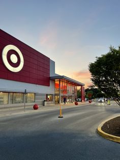 an empty street in front of a building with a target sign on it's side