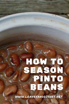 a pot filled with beans sitting on top of a wooden table