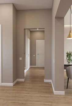 an empty room with hard wood flooring and white trim on the walls is seen in this image