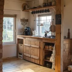 an old fashioned kitchen with wooden cabinets and shelves