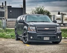 a black suv parked in a parking lot