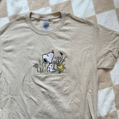 cotton sand t-shirt with embroidered design. unisex adult sizing. these are made to order! please allow 2-4 weeks for shipment ᵕ̈ Cool Shirts Aesthetic, Spring Snoopy, Snoopy Clothes, Snoopy Crewneck, Snoopy Shirt Aesthetic, Snoopy Tshirt Design, Snoopy Tshirts, Snoopy Hoodie Sweatshirts, Snoopy Tshirt