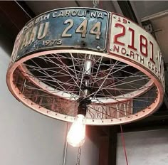 a light hanging from the ceiling in a building with an old sign on it's side