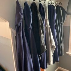 a bunch of clothes hanging on a rack