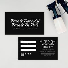 two black and white business cards sitting on top of each other next to a blow dryer