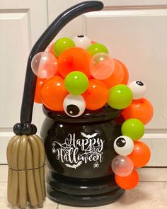 a halloween bucket filled with lots of balloons