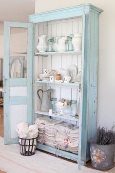 an old china cabinet is filled with dishes