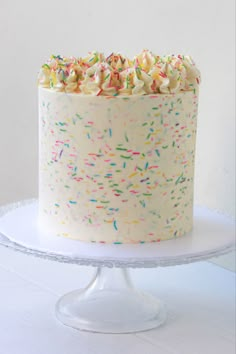 a white cake with sprinkles on it